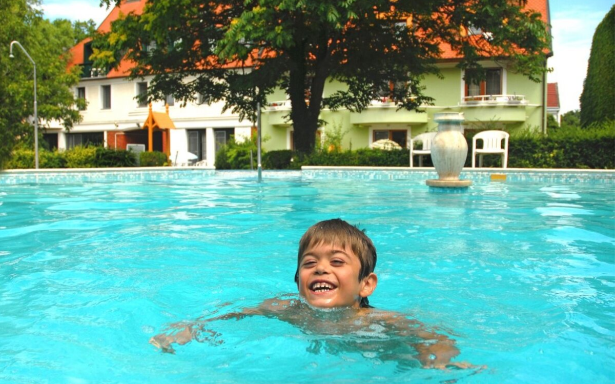 Abtei Club Hotel Keszthely - glückliches Kind, das in den Außenpool schwimmtn