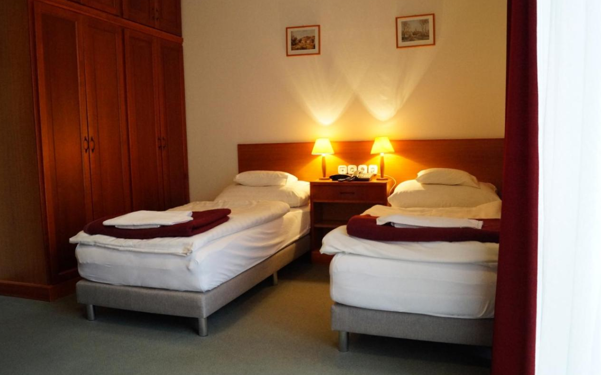 The comfortable beds at Hotel Ovit provide a peaceful rest for the guests.