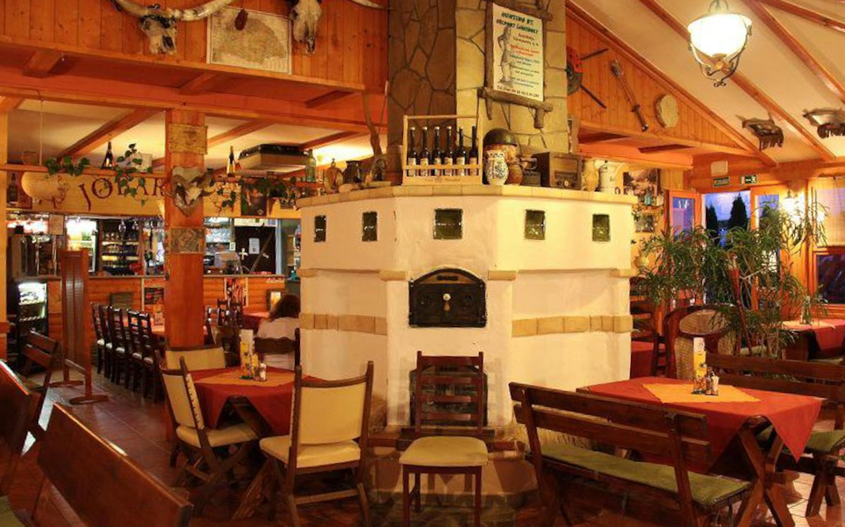 Good Friend Restaurant with a fireplace in the center of the interior