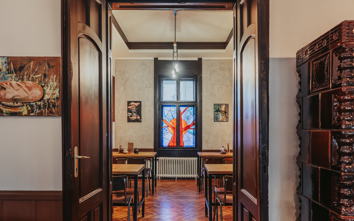 The upstairs of Pajti Coffeehouse is decorated with many beautiful pictures and painted glass windows.